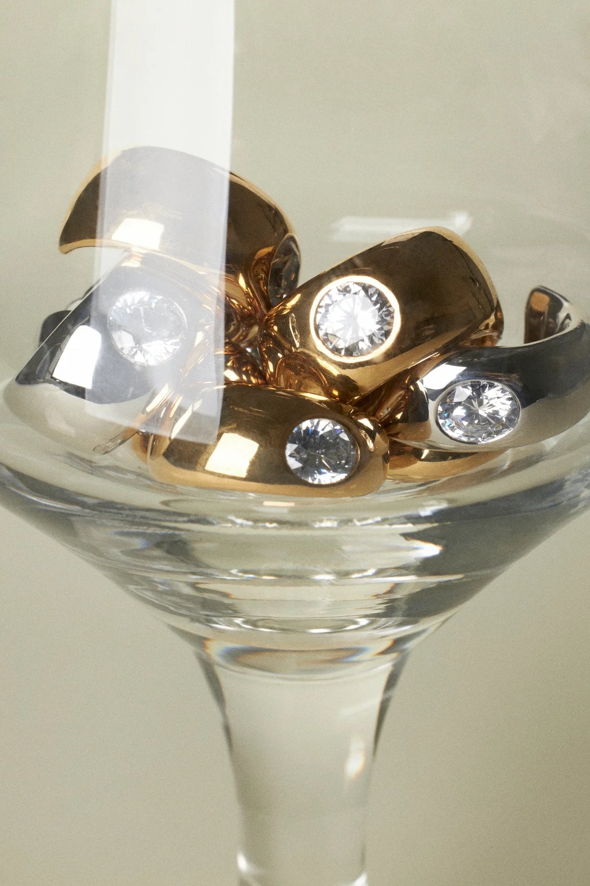sustainable luxury jewelry rings with crystals in a glass bowl