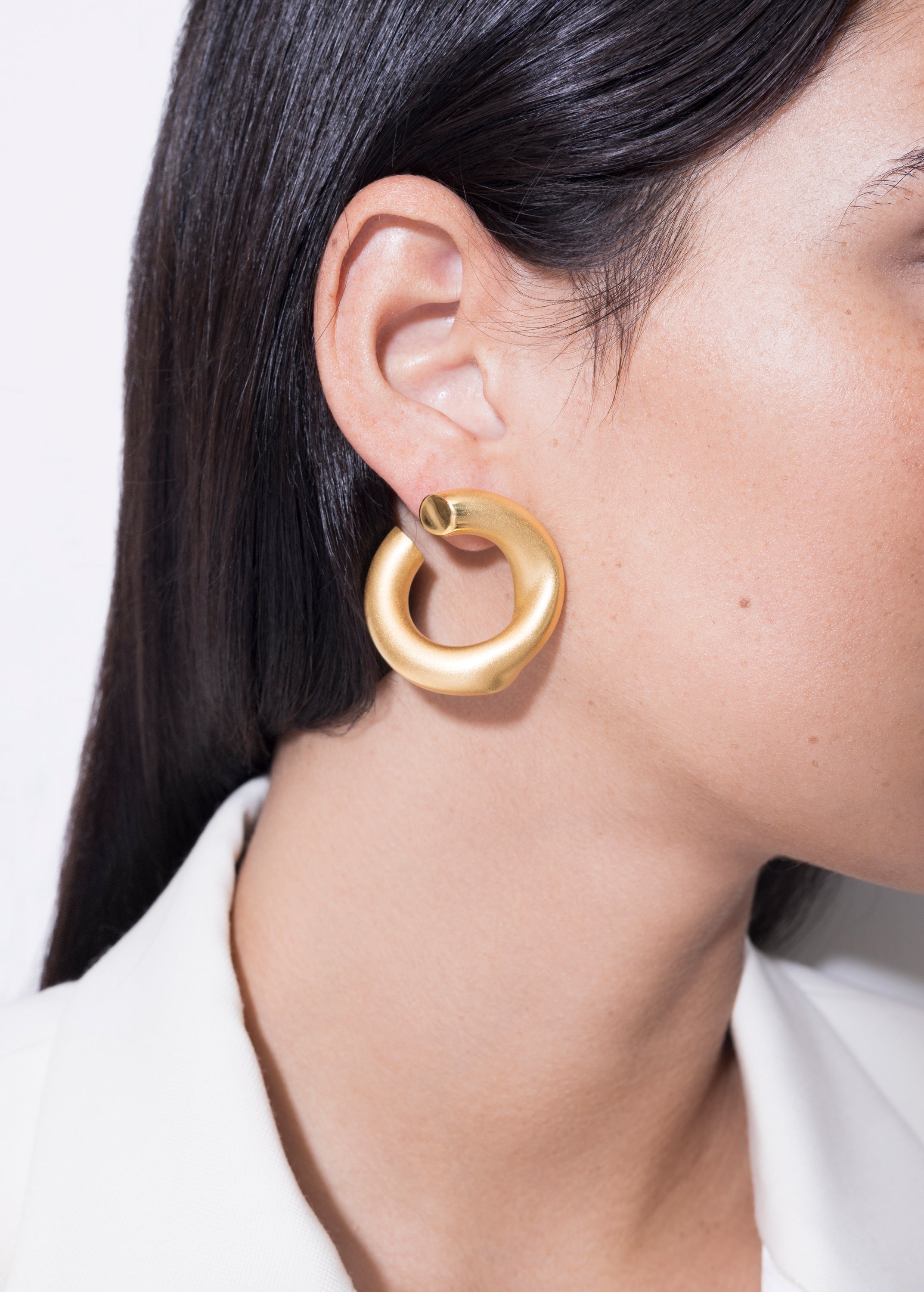 model wearing claudine earrings in gold