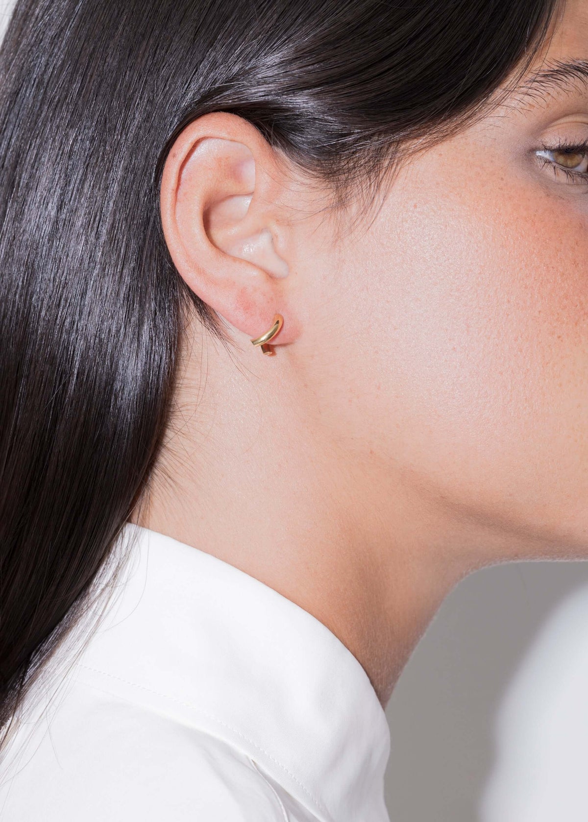 Model showcasing 18k diamond hoop earrings, elegant design, handmade in Portugal.