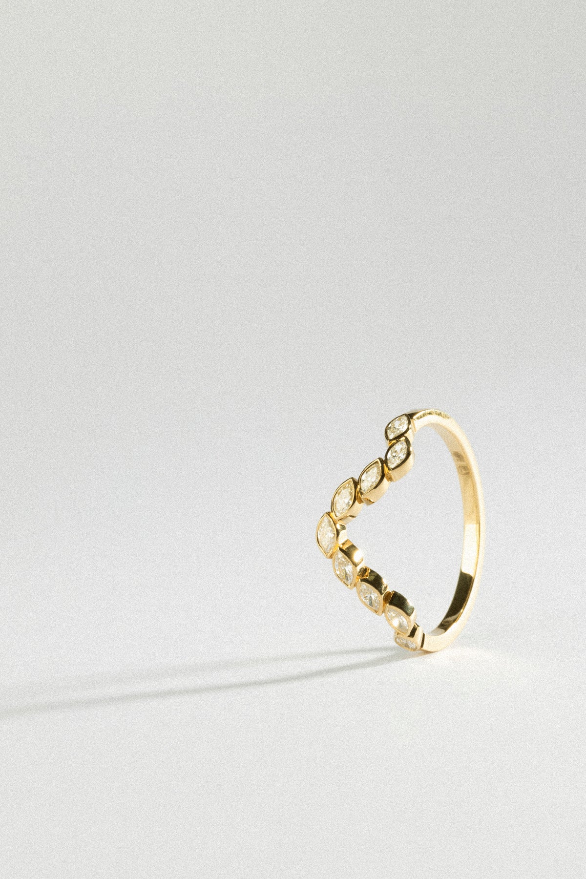 A golden ring featuring multiple gemstone accents, part of the honeymoon jewelry collection.