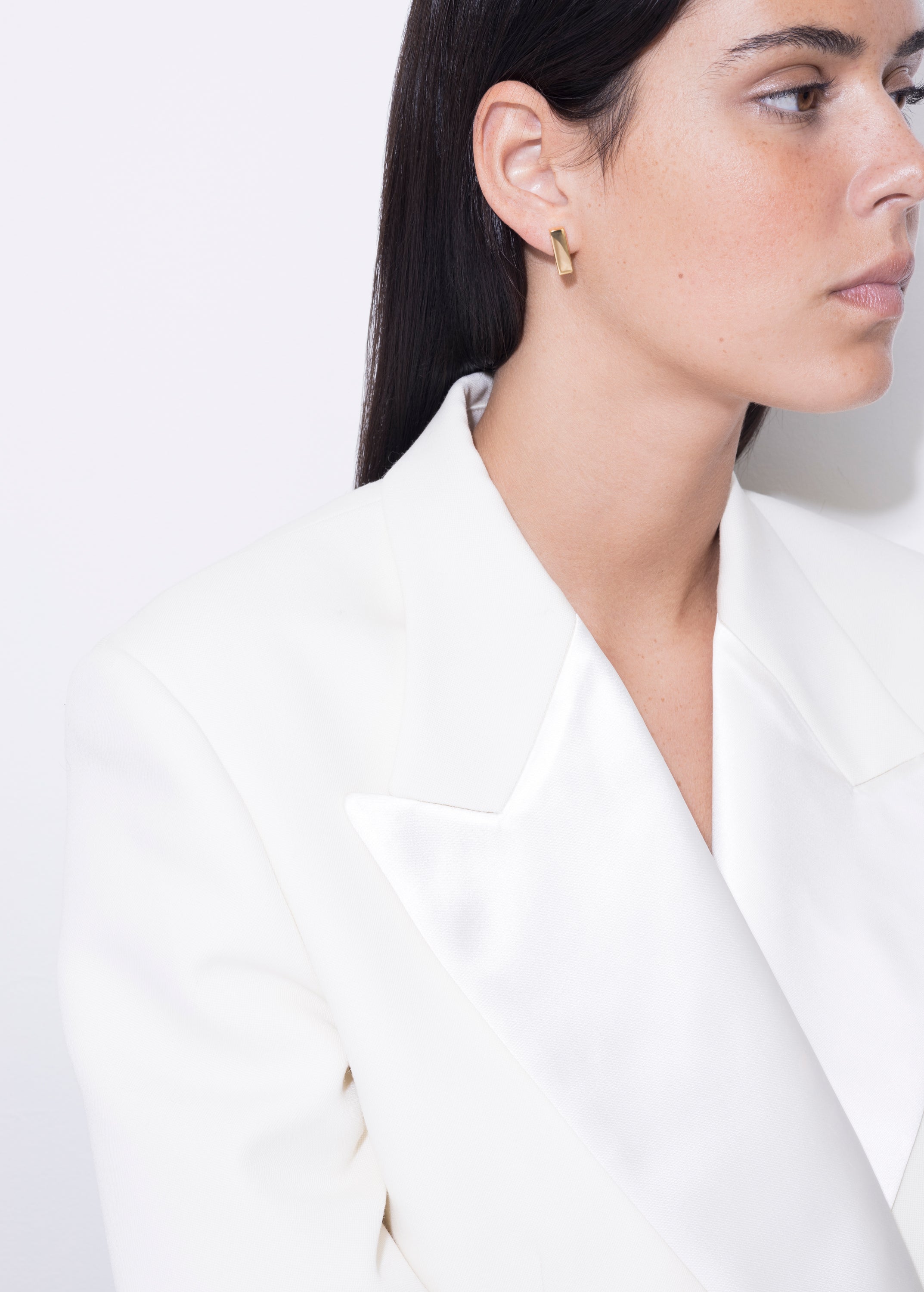 model wearing eliza earrings in gold