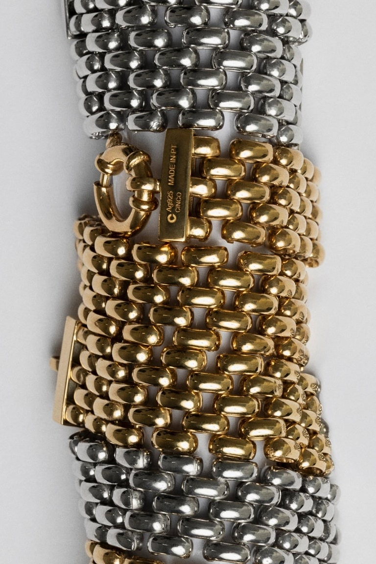 Gold and silver chain bracelets on a white background