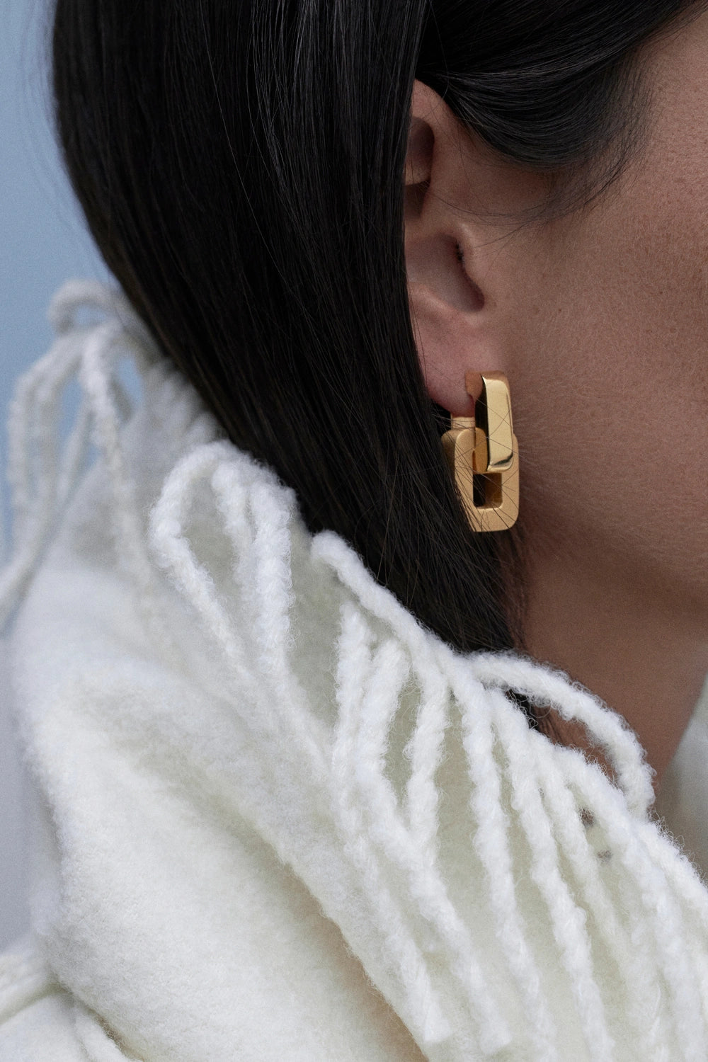 model wearing gold earrings