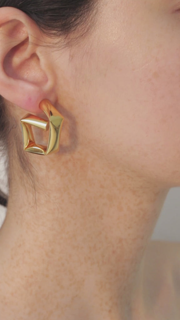 video of model wearing tina wrapped earrings in gold 