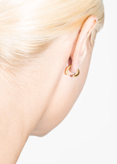 Elegant close-up of 18k diamond hoop earrings worn, showcasing unique design details.